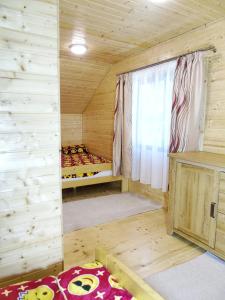 a room with a bed in a wooden cabin at Cabana Larisei in Cluj-Napoca