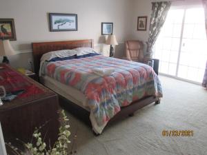 a bedroom with a bed with a colorful comforter at Peaks Wildernest House Bed and Breakfast - Vaccinations Required in Flagstaff