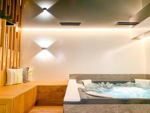a jacuzzi tub in a bathroom with lights at Ari Resort Apartments in Zermatt