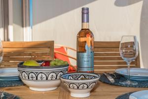 a bottle of wine sitting on top of a table at BUQEZ Eco Resort - beachfront 20 & House 42 in Drage