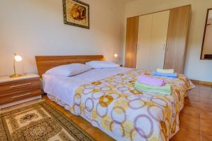 a bedroom with a large bed and a dresser at Apartment Dumičić 1 in Rab