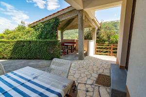 a patio with a table and chairs on a patio at Apartment Dumičić 1 in Rab
