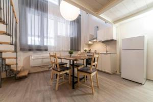 a kitchen with a table and chairs in a room at Casa Pinù in Bologna