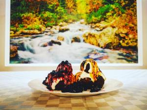 two desserts on a plate on a table at Doftana Apartaments in Teşila