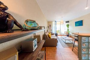 a living room with a statue of a dog on a counter at TERRASSE Vue MARINA - PARKING Privé - Port Commerces & PLAGE à PIED - Vue Exceptionnelle - RétroMirabeau "Côté Mer" in Gruissan +38 photos