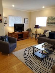 a living room with a couch and a tv at Desert Rose Villas - Private One Bedroom in Old Town Scottsdale in Scottsdale
