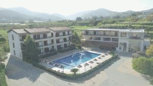 an aerial view of a building with a swimming pool at Vouni King Hotel in Limnitis