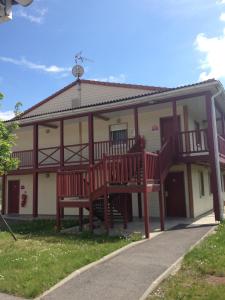 a house with a large deck with two benches at Couett' Hotel Rumilly in Rumilly