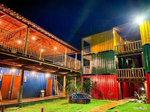 a building with colorful doors and balconies at night at Trakai Suites in Ubatuba