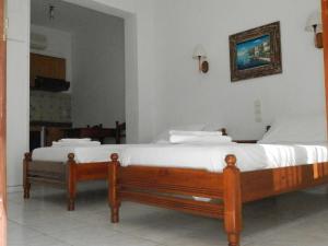 a bed in a room with a picture on the wall at Aeolos Hotel Apartments in Gythio