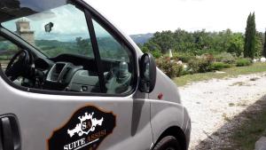 a white car with a emblem on the side of it at Suite Assisi in Assisi