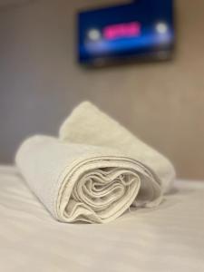 a towel sitting on top of a bed at CEZARA in Galaţi