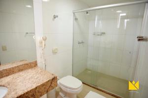 a bathroom with a shower with a toilet and a sink at Brasília Imperial Hotel e Eventos in Brasilia