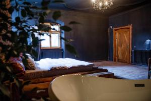 a bathroom with a bed and a bath tub at World Studio 5 in Sibiu