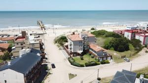 an aerial view of a beach with houses at Apart Amabile Sul Mare in Villa Gesell