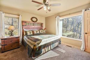 a bedroom with a bed and a ceiling fan at Walnut Ridge Cabin. Sleeps 7-11! Hot tub, pool table, minutes to downtown Gatlinburg! in Gatlinburg