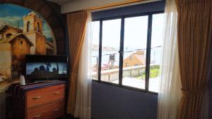 TV a/nebo společenská místnost v ubytování Hotel Utama