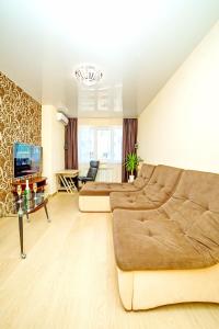 a large living room with a couch and a television at Alex Apartment Сеть апартаментов Бесконтактное заселение 24-7 in Poltava