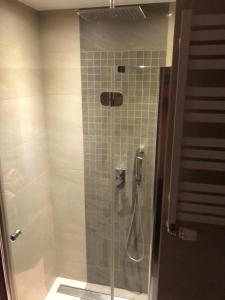 ein Bad mit einer Dusche und einer Glastür in der Unterkunft Apartament White glove Kołobrzeska in Danzig