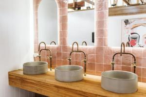 two metal bowls on a wooden counter in a bathroom at The Woods Farm Jervis Bay in Tomerong