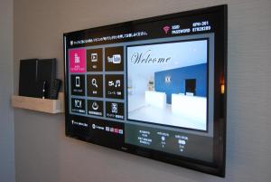 a television screen on a wall in a room at Kotohira Park Hotel in Kotohira