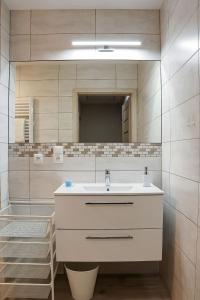 a bathroom with a sink and a mirror at NADMORSKI-DOM Pobierowo Summer-house in Pobierowo