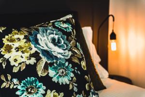 a blanket with blue and white flowers on a bed at Daylesford Spa Accommodation in Daylesford