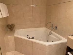 a white bath tub in a bathroom at Adelphi#5 in Echuca