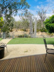 a chair sitting on a deck with a park at Adelphi#5 in Echuca