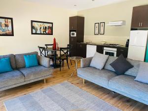 a living room with two couches and a kitchen at Adelphi#5 in Echuca