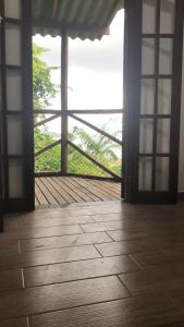 an open room with a wooden floor and a view of the ocean at Casa Mar e Montanha 2, deck com vista para o mar in Trindade