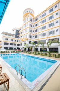 a swimming pool in front of a building at Siddhartha Hotel Grand City in Birtamode