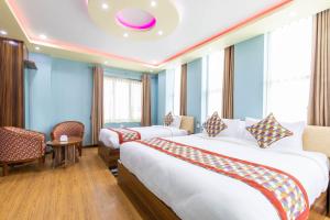 En eller flere senger på et rom på Siddhartha Hotel Grand City