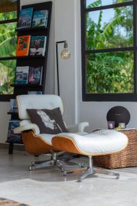 a white chair sitting in a living room at Villa Lempuyangdream in Karangasem