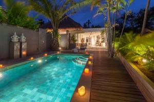 a swimming pool in the backyard of a villa at night at Villa Lempuyangdream in Karangasem +10 photos