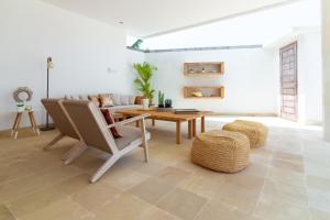 a living room with a couch and a table at Villa Mangodream in Karangasem
