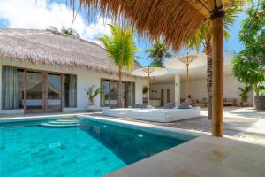 a villa with a swimming pool and a resort at Villa Mangodream in Karangasem