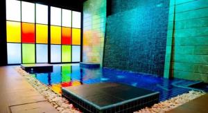 a room with a pool of water with a colorful wall at Fourteen Again in Pattaya