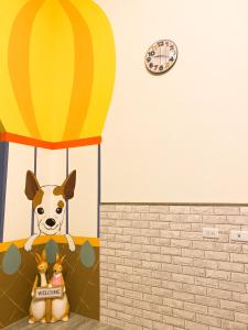 a dog riding a hot air balloon with two stuffed animals at Mo Dou Homestay in Taitung City