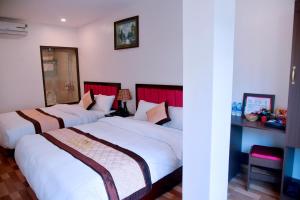 Postel nebo postele na pokoji v ubytování SAPA KING HOTEL HUNG VUONG HOTEl