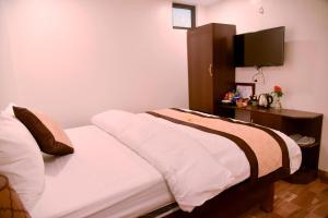 Postel nebo postele na pokoji v ubytování SAPA KING HOTEL HUNG VUONG HOTEl