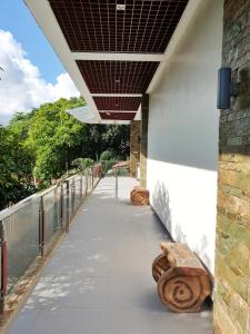 a walkway with benches on the side of a building at MJ Pension House in Talisay