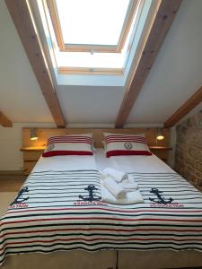 a bedroom with a large bed with a skylight at Seafront Apartment 2 in Cavtat