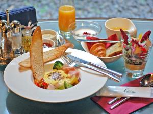 a table with a plate of breakfast food on it at Hotel Trusty Tokyo Bayside in Tokyo