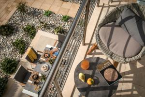 an overhead view of a table and chairs on a balcony at Aether by Nymphs residence I in Kókkinos Pírgos