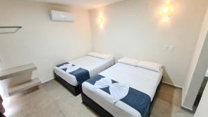 Postel nebo postele na pokoji v ubytování Hotel Vista Laguna Bacalar