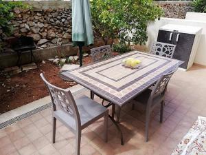 a table and chairs with a plate of fruit on it at Casa Isulidda in San Vito lo Capo