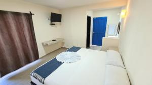 Postel nebo postele na pokoji v ubytování Hotel Vista Laguna Bacalar