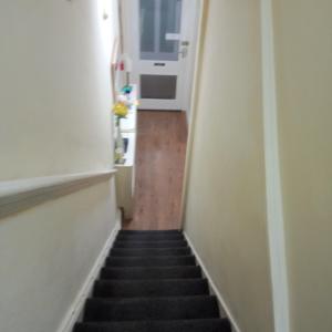 a hallway with stairs leading to a kitchen and a door at The Wilton Weymouth in Weymouth