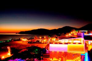 a city lit up at night with lights at Belcekiz Beach Club - All Inclusive in Oludeniz